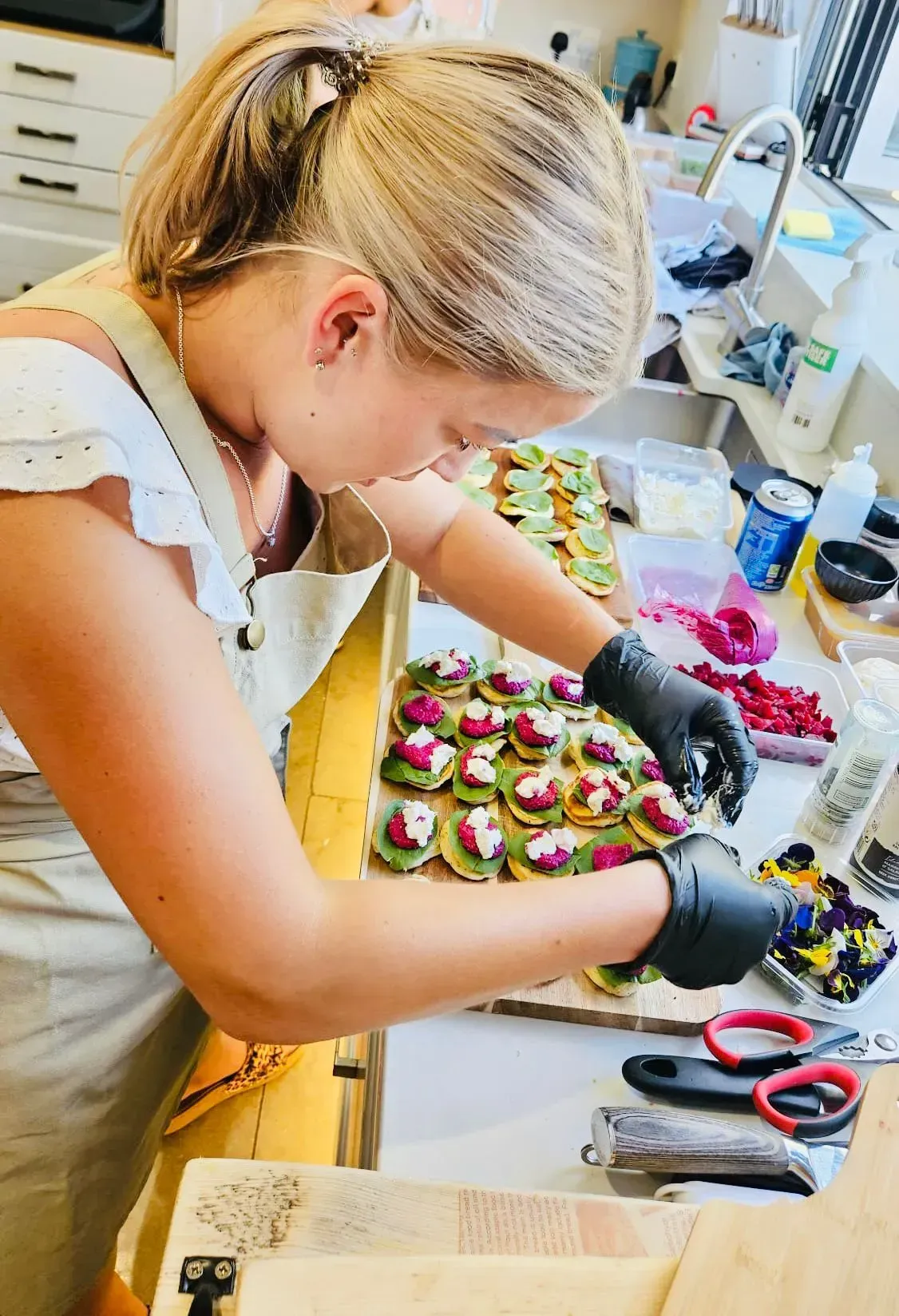 Bianca in professional chef whites smiling at the camera